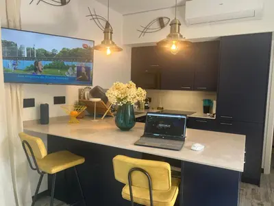a kitchen with a desk with a laptop on a counter at Barco - casa con jardín privado frente al mar in Mareny Barraquetas