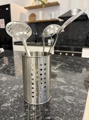 a metal pot with utensils on a kitchen counter at Across from the Turia Modern City Stay in Valencia