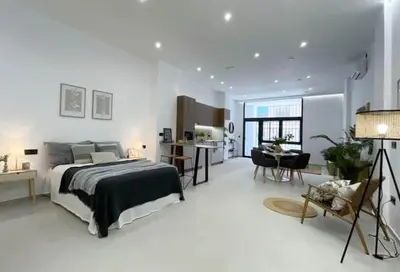 a bedroom with a bed and a desk and a kitchen at Sunny Stay Valencia 4 pax wifi in Valencia