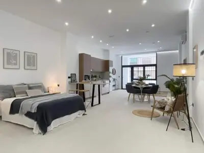 a bedroom with a bed and a living room and a kitchen at Sunny Stay Valencia 4 pax wifi in Valencia