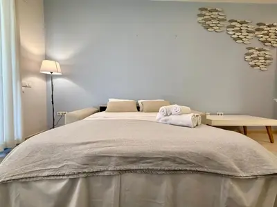 a bedroom with a large bed with two towels on it at Reinapart Patacona Balcony Seaview in Valencia