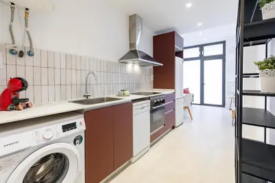 a kitchen with a washing machine and a sink at My Loft 4 You Democracia II in Valencia