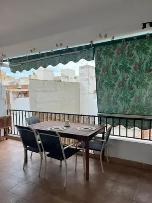 a table and chairs sitting on top of a balcony at District Key - Puerto de Sagunto, Virgen Losar in Puerto de Sagunto