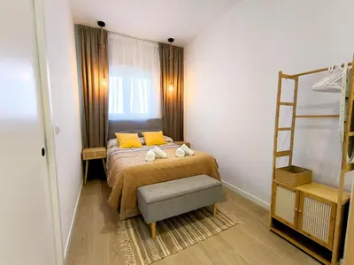 a bedroom with a bed with yellow pillows and a ladder at The Sunshine Apartment in Valencia