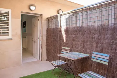 a patio with two chairs and a table and a fence at L'Otelet By Sweet in Valencia