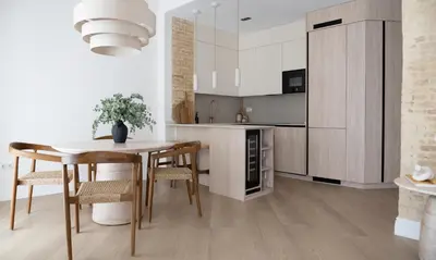a kitchen with a wooden table and a dining room at Valencia Boutique Stays - High End Apartment in Ruzafa for long stays in Valencia