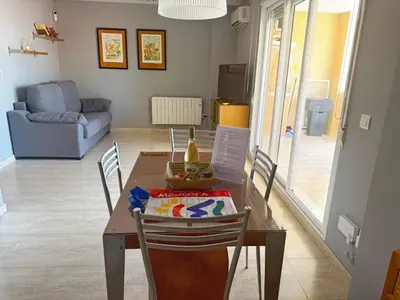 a dining room with a table with chairs and a couch at Raquel Host Moncofar in Moncófar