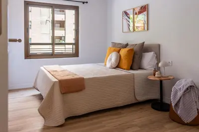 a bedroom with a bed and a window at VLC Host - Belgica Apartments in Valencia