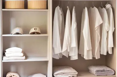 a closet with white shirts and hats and towels at VLC Host - Belgica Apartments in Valencia