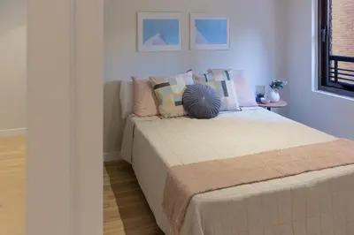 a bedroom with a bed with pillows on it at VLC Host - Belgica Apartments in Valencia