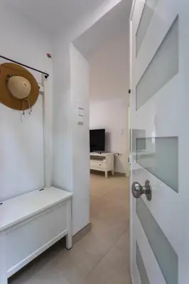 a white room with a door and a television at Casa La Mar in Mareny Blau