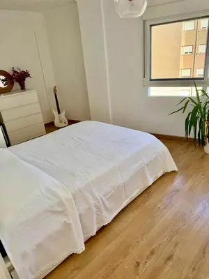 a white bed in a room with a window at Private Room in Central Valencia in Valencia