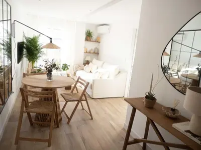 a living room with a table and a white couch at GuestReady – Luminous City Getaway in Valencia