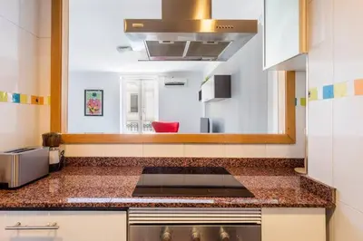 a kitchen with a counter top with a stove top at Super Flat 3 rooms 1 toilet Center wifi AC in Valencia