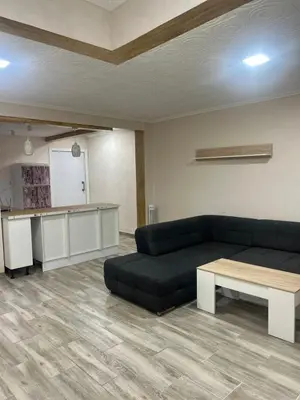 a living room with a black couch and a table at Apartamento acogedor playa Cullera in Cullera