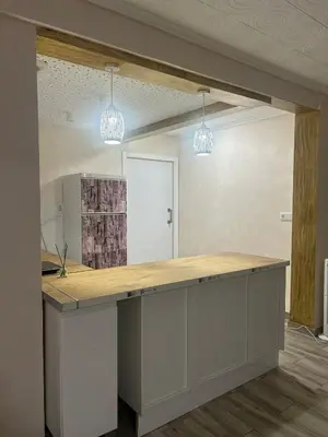 a kitchen island in a room with two lights at Apartamento acogedor playa Cullera in Cullera