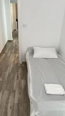 a bed with a towel on it in a room at Apartamento acogedor playa Cullera in Cullera
