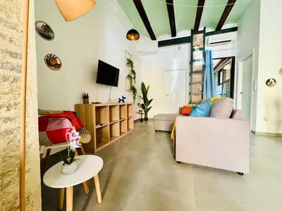 a living room with a couch and a table at Mediterranean Flat next to the Historic Center in Valencia