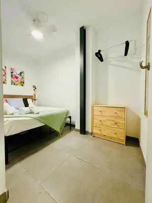 a bedroom with a bed and a wooden dresser at Mediterranean Flat next to the Historic Center in Valencia