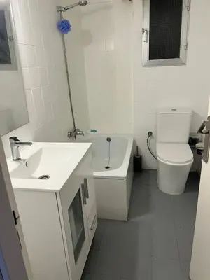 a white bathroom with a sink and a toilet at Aldair in Valencia