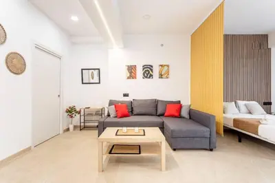 a living room with a couch and a table at Torrefiel Charm Apartment in Valencia