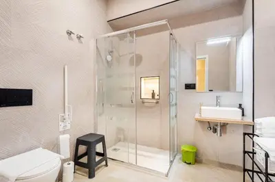 a bathroom with a shower and a toilet and a sink at Torrefiel Charm Apartment in Valencia
