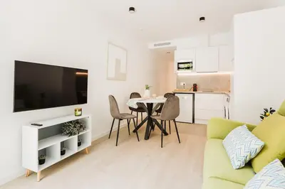 a living room with a table and a kitchen at Apartamento en Valencia in Valencia