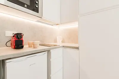 a kitchen with white cabinets and a red appliance at Fantastico apartamento en Valencia in Valencia