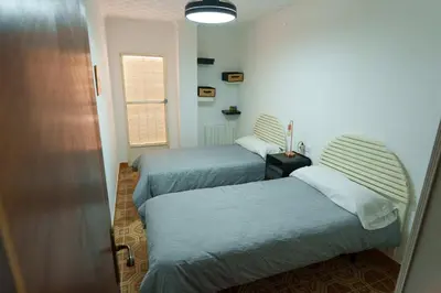 a bedroom with a bed with a green blanket on it at Las Salericas in Chella