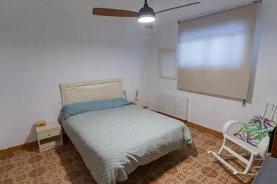 a bedroom with a bed with a mirror and a table at Las Salericas in Chella