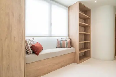 a room with a window seat with pillows at VLC Host - Martí Apartments in Valencia