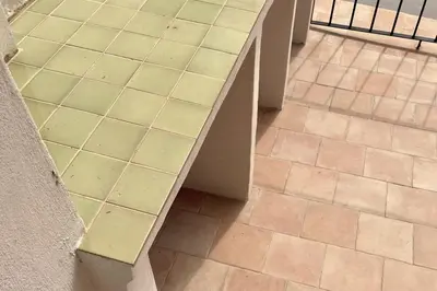 a bench sitting on a tile floor next to a wall at Casa Juana in Valencia