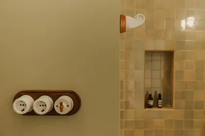 a bathroom with three rolls of toilet paper on a wall at Casa Lina in Valencia
