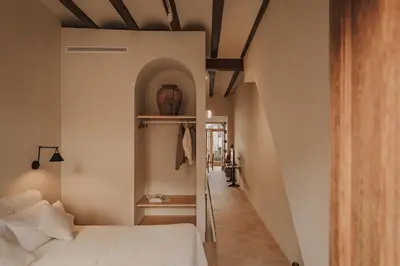 a bedroom with a white bed and a hallway at Casa Lina in Valencia