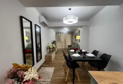 a dining room and living room with a table and chairs at Las Arenas 1 Apartamento Playa in Valencia