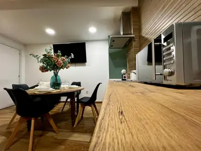 a kitchen with a table with chairs and a microwave at Playa Las Arenas 2 Apartamento in Valencia