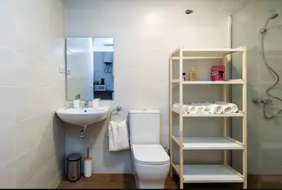 a bathroom with a white toilet and a sink at Nuevo acogedor cerca del Centro in Valencia