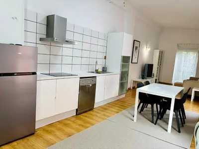 a kitchen with a table and a refrigerator and a table and chairs at Reina loft in Valencia
