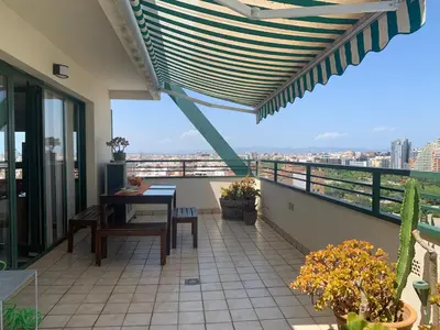 a balcony with a table and a view of the city at Atico Ciudad de las Ciencias Terraza y parking in Valencia