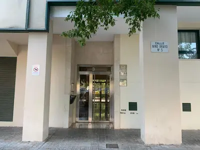 a building with a door with a sign on it at Atico Ciudad de las Ciencias Terraza y parking in Valencia