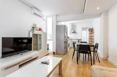 a kitchen and living room with a table and chairs at GuestReady - Comfort in Valencia in Valencia