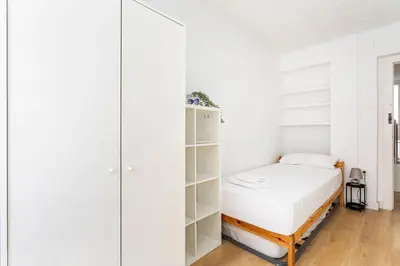 a bedroom with a bed and a book shelf at GuestReady - Comfort in Valencia in Valencia