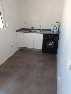 a kitchen with a sink and a washing machine at Triplex 4 Bed Penthouse Sea Views Casa Privee - Lux Four bed Two bath Terraces & Balconies in Puerto de Sagunto