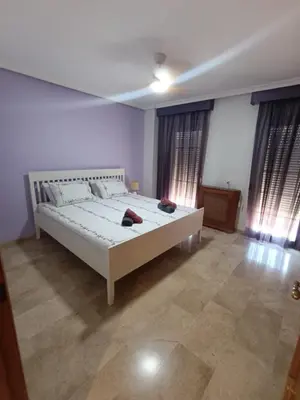 a bedroom with a large white bed and windows at Triplex 4 Bed Penthouse Sea Views Casa Privee - Lux Four bed Two bath Terraces & Balconies in Puerto de Sagunto