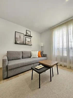 a living room with a couch and a coffee table at Chic Escape Apartment in Godella