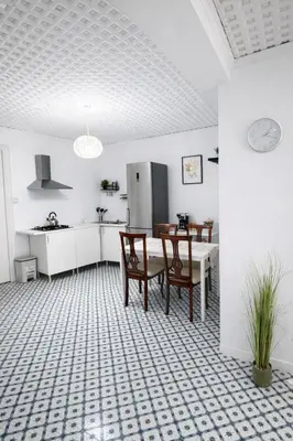 a kitchen with a table and chairs and a refrigerator at Cullera Center, 15 min Beach in Cullera