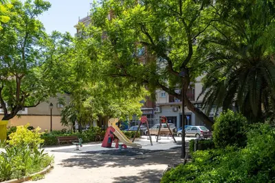 a playground with a slide in a park with trees at VL - Casa Girasol in Valencia