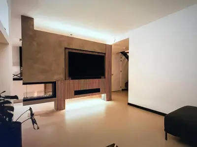 a living room with a large television on a wall at Costa de Valencia Comfort in Torrent
