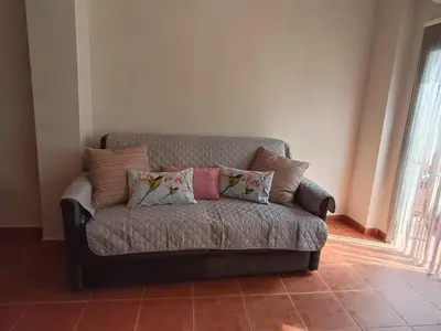a couch with pillows on it in a living room at La Senia in Moncófar