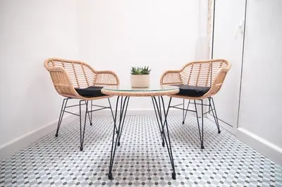 two chairs and a table with a potted plant on it at Grandma's fishermen's house in Cabanyal in Valencia